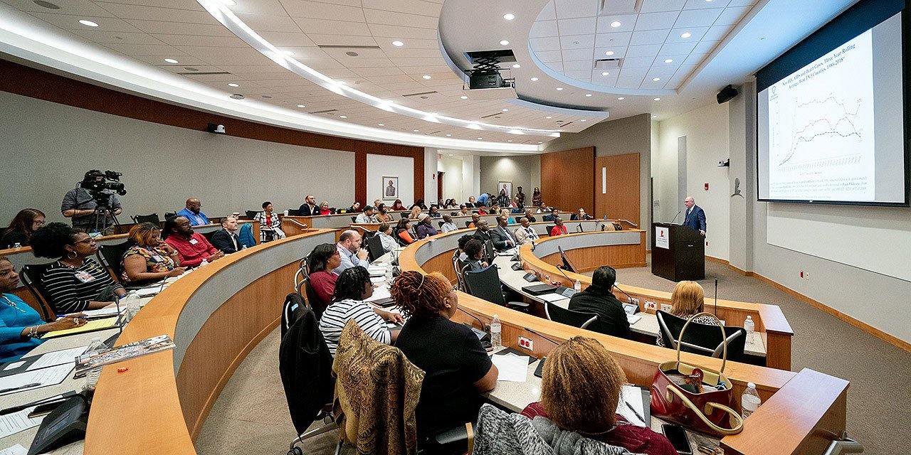 A person holding an AIDS ribbon in cupped hands
